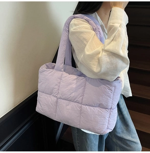 Detailed shoulder view of a lavender quilted tote bag with soft down-like padded texture