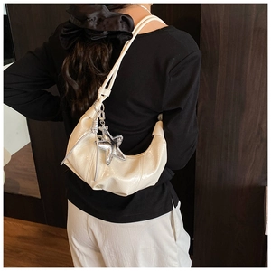 Chic cream white crescent bag in wrinkled patent leather with silver star charm detail
