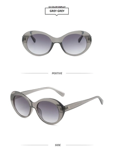 Detail view of retro oval transparent grey sunglasses with gradient lenses and gold hinges