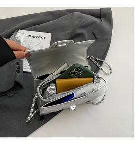 Detail view of the silver quilted chain bag's spacious interior and metallic twist lock