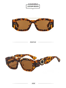 Detail view of leopard print punk sunglasses with gold double bridge and hollow metal trim
