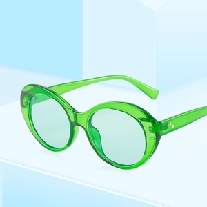 Fashionable emerald green oval sunglasses with retro translucent frames and gold rivet details