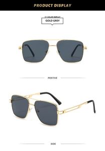 Detail view of gold metal double bridge frame and grey lenses on aviator sunglasses