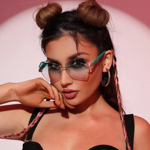 Fashionable rimless geometric sunglasses with blue-grey gradient lenses on a model