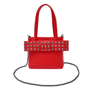 Red rivet shoulder bag with large bow and metal chain strap on a white background