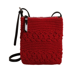Red knit tote bag with floral pattern, black leather strap and zipper detail on white background