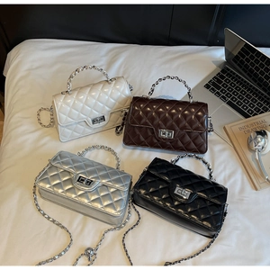 Close-up of quilted crossbody bags with metal twist locks and chain straps in four colors