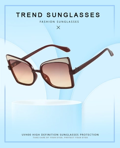 Detailed view of women's cat eye sunglasses with burgundy frames and UV400 gradient lenses