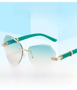 Detail view of rimless gradient lenses with polygonal edges and green metal temples