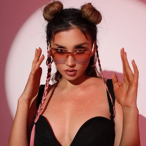 Fashionable rimless sunglasses with pink-orange gradient lenses and gold metal bridge