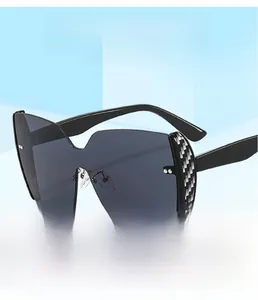 Detail of carbon fiber texture on oversized wrap-around sunglasses with metal nose pads