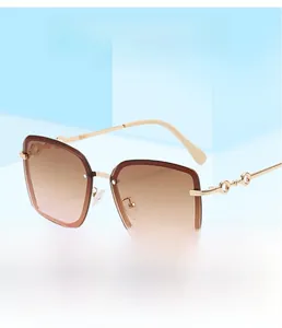Detail view of square rimless gradient brown lenses with golden hollow-out metal temples