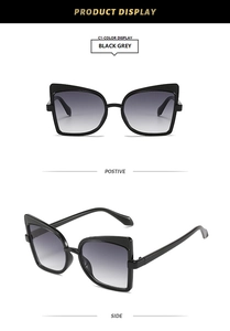 Front and side views of black oversized cat-eye sunglasses with gradient grey lenses