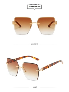 Detail view of rimless square sunglasses with gradient brown lenses and leopard arms