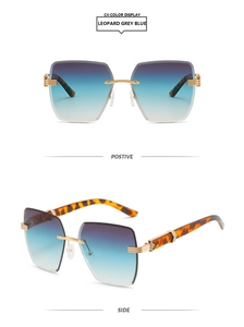 Detail view of rimless square sunglasses with gradient blue lenses and leopard temples