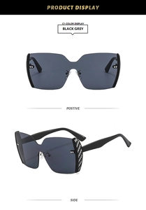 Detail of black grey flat top sunglasses featuring carbon fiber texture on temples