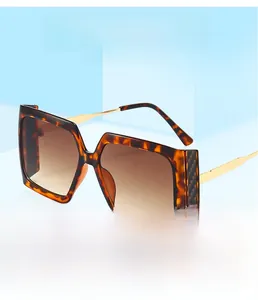 Detail of square oversized sunglasses with tortoiseshell frames and gold temples