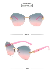 Detail view of rimless geometric sunglasses with pink and green gradient lenses and gold frames