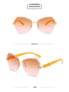 Detail view of rimless geometric sunglasses with orange gradient lenses and gold hinges