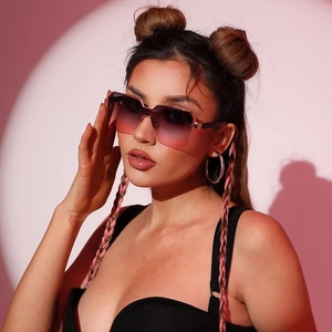 Close-up of square oversized sunglasses with pink-purple gradient lenses and dark temples