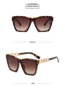Macro detail of leopard brown oversized sunglasses with elegant gold chain temples