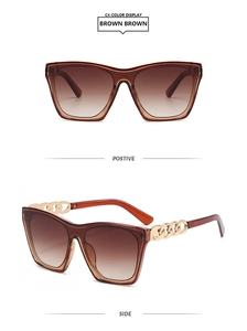 Detail of square oversized brown gradient sunglasses with gold metal chain temple design