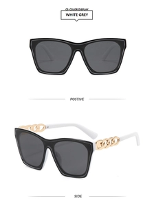 Detail view of square frame sunglasses with thick gold metal chain and white temples