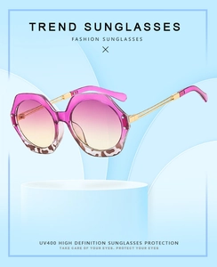 Detail of gradient pink lenses and leopard print frame with slim gold metal temples