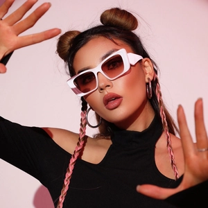 Close-up of stylish white thick rectangle sunglasses with dark brown gradient lenses