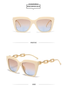 Détail de lunettes de soleil rectangulaires beige avec branches chaîne dorée et verres