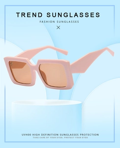 Detail of trendy square frame sunglasses with pink plastic frames and UV400 lenses