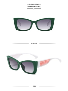 Détail de lunettes de soleil œil de chat avec monture vert foncé et branches à motifs orange