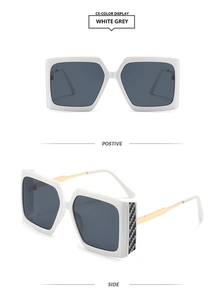 Detail view of square white sunglasses with grey lenses and gold metal temples