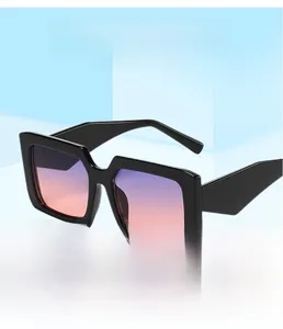 Detail of square oversized sunglasses with gradient lenses on blue geometric stands