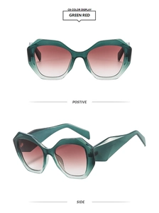 Detail view showing green translucent polygonal cat eye frames with red gradient lenses