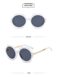 Detail of white hexagonal sunglasses with grey lenses and golden metal temples