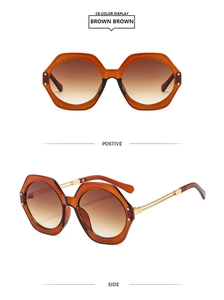 Detail view of hexagonal brown resin frames with gradient lenses and gold metal temple arms
