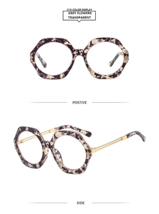 Close-up of geometric hexagonal glasses with grey floral frames and gold metal temples