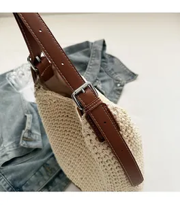 Detail of hand-woven texture with dark brown leather adjustable strap and metal buckle