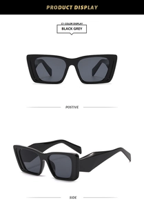 Detail view of black square sunglasses with grey lenses and thick geometric temples