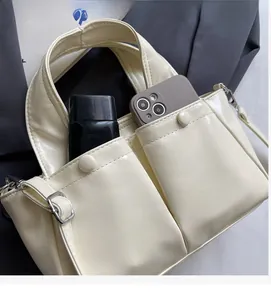 Detail of minimalist tote bag showing front large pockets with high storage capacity