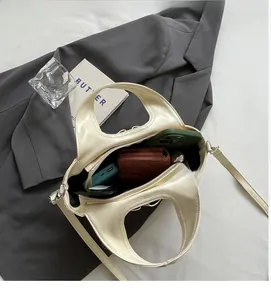 Top view of cream tote bag interior showing spacious storage for phone and wallet