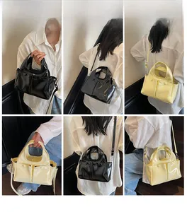 Detail shots of large glossy patent leather tote bags in black and beige with straps