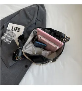 Large capacity black leather shoulder bag showing interior space for iPad and essentials