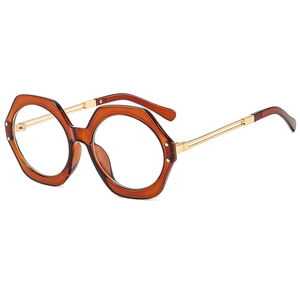 Octagonal oversized sunglasses in amber resin with gold metal temples on white background