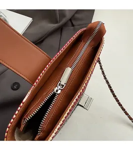 Detailed macro view of the smooth metal zipper and inner lining of the rainbow woven bag