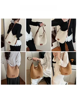 Detail of woven straw tote bag with leather straps in cream and caramel colors