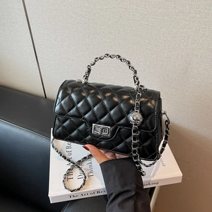 Classic black quilted baguette bag with silver chain strap and metal turn-lock closure