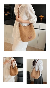 Detail of woven cotton bucket bag with brown faux leather strap and oval logo patch