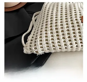 Macro detail of white crochet hollow knit texture on the drawstring bucket backpack
